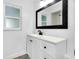 A bathroom featuring a large vanity, a black faucet and natural light at 140 Poinsettia Ne Cir, Port Charlotte, FL 33952
