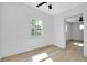 This bedroom offers neutral walls, a ceiling fan and natural light, creating a tranquil space at 140 Poinsettia Ne Cir, Port Charlotte, FL 33952