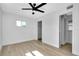 This bedroom includes light hardwood flooring, ceiling fan and a closet for ample storage at 140 Poinsettia Ne Cir, Port Charlotte, FL 33952