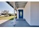 Beautiful entrance with a vibrant blue door and white accent pillars at 140 Poinsettia Ne Cir, Port Charlotte, FL 33952