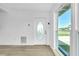 Bright entrance features an oval glass door and large adjacent window at 140 Poinsettia Ne Cir, Port Charlotte, FL 33952