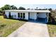 Charming home with a well-maintained lawn and a covered carport and driveway at 140 Poinsettia Ne Cir, Port Charlotte, FL 33952