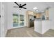 Bright kitchen features stainless appliances, neutral cabinetry, granite counters, and sliding doors to the sunroom at 140 Poinsettia Ne Cir, Port Charlotte, FL 33952