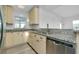 Kitchen featuring granite countertops, stainless steel appliances, and timeless cream-colored cabinets at 140 Poinsettia Ne Cir, Port Charlotte, FL 33952