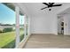 Bright and airy living room with large windows and a modern ceiling fan at 140 Poinsettia Ne Cir, Port Charlotte, FL 33952