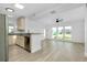 Open floor plan featuring a combined kitchen and living room with stainless appliances and plenty of natural light at 140 Poinsettia Ne Cir, Port Charlotte, FL 33952