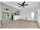 Open floor plan connects living area to the modern kitchen with stainless appliances at 140 Poinsettia Ne Cir, Port Charlotte, FL 33952