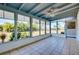 Enclosed patio with tiled floor and screened windows offering an outdoor view at 140 Poinsettia Ne Cir, Port Charlotte, FL 33952
