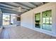 View of the tiled sunroom with ceiling fan, sliding glass doors, and access to the backyard at 140 Poinsettia Ne Cir, Port Charlotte, FL 33952
