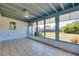 Bright tiled sunroom with large windows for backyard view, and ceiling fan for added comfort at 140 Poinsettia Ne Cir, Port Charlotte, FL 33952
