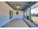 Tiled sunroom with large windows offering backyard view, features a ceiling fan and access to the yard at 140 Poinsettia Ne Cir, Port Charlotte, FL 33952