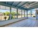 Bright sunroom with tile floors, ceiling fan, and large windows overlooking the backyard at 140 Poinsettia Ne Cir, Port Charlotte, FL 33952