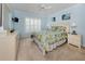Light and airy bedroom with blue walls, tropical bedding, and plantation shutters at 143 Braemar Ave, Venice, FL 34293