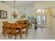 Bright dining room with a large mirror, chandelier and elegant furnishings at 143 Braemar Ave, Venice, FL 34293