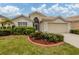Charming single-story home with manicured landscaping and a two-car garage at 143 Braemar Ave, Venice, FL 34293