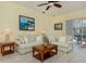 Cozy living room with neutral decor and comfortable seating, next to open kitchen at 143 Braemar Ave, Venice, FL 34293