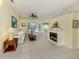 Comfortable living room with a fireplace and neutral-colored walls, with access to the patio at 143 Braemar Ave, Venice, FL 34293