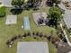 Aerial view of the community playground with basketball court, volleyball, and seating area at 143 Braemar Ave, Venice, FL 34293