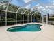 This screened-in pool has a safety handrail and shallow steps to enter it at 143 Braemar Ave, Venice, FL 34293