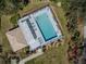 Overhead view of a community pool with sun loungers and shaded pergola area at 143 Braemar Ave, Venice, FL 34293