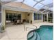 Screened in patio area featuring dining area and a pool with a safety handrail at 143 Braemar Ave, Venice, FL 34293