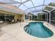 This screened-in pool features a safety handrail and steps into the pool at 143 Braemar Ave, Venice, FL 34293