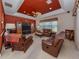 Comfortable living room with leather furniture, ceiling fan, and accent wall at 148 Wading Bird Dr, Venice, FL 34292