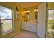 Bright bathroom with double sinks, ample cabinet space, and decorative lighting at 172 Altair Rd, Venice, FL 34293