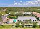 Scenic aerial view of condos surrounded by lush greenery with a refreshing pool area at 1730 Manasota Beach Rd # 215, Englewood, FL 34223