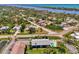 Aerial view of condos featuring a refreshing pool and well-maintained grounds near a scenic waterway at 1730 Manasota Beach Rd # 215, Englewood, FL 34223