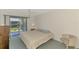 Comfortable bedroom with sliding glass door to patio with garden view at 1730 Manasota Beach Rd # 215, Englewood, FL 34223