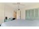 Bedroom features closet with louvred door and modern desk with a blue color scheme at 1730 Manasota Beach Rd # 215, Englewood, FL 34223