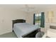 Bedroom with a dark bed, dark wood furniture, and window with shades at 1730 Manasota Beach Rd # 215, Englewood, FL 34223