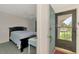 Comfortable bedroom with a ceiling fan, desk, and a view from the doorway at 1730 Manasota Beach Rd # 215, Englewood, FL 34223