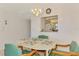 Bright dining area featuring a decorative chandelier and a pass-through to the kitchen at 1730 Manasota Beach Rd # 215, Englewood, FL 34223