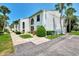Charming condo building with well-manicured landscaping, offering a welcoming curb appeal in a sunny setting at 1730 Manasota Beach Rd # 215, Englewood, FL 34223