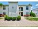 Inviting condo exterior with tidy landscaping, providing a warm and welcoming entrance at 1730 Manasota Beach Rd # 215, Englewood, FL 34223