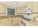 Well-maintained kitchen with granite countertops, stainless steel sink, and ample cabinet space at 1730 Manasota Beach Rd # 215, Englewood, FL 34223