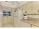 Bright kitchen features granite countertops, and cream-colored cabinetry at 1730 Manasota Beach Rd # 215, Englewood, FL 34223
