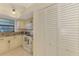 Functional kitchen with granite countertops, bright lighting, and white appliances at 1730 Manasota Beach Rd # 215, Englewood, FL 34223