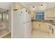 Kitchen featuring cream colored cabinets and bright lighting at 1730 Manasota Beach Rd # 215, Englewood, FL 34223