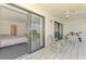 Screened porch with tiled floors connects to bedroom and offers serene outdoor views at 1730 Manasota Beach Rd # 215, Englewood, FL 34223