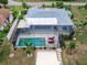 Home featuring a screened in pool and boat dock at 18302 Burkholder Cir, Port Charlotte, FL 33948