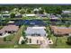 Home featuring a spacious driveway and waterfront access at 18302 Burkholder Cir, Port Charlotte, FL 33948
