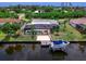 An aerial shot showcases the waterfront home, pool, boat dock, and canal for ultimate outdoor living at 18302 Burkholder Cir, Port Charlotte, FL 33948