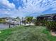 A canal-front yard, blending lush greenery with waterfront views, complete with a private boat dock at 18302 Burkholder Cir, Port Charlotte, FL 33948