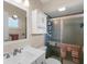 Bathroom featuring a white vanity, mirrored wall cabinet, and glass shower at 18302 Burkholder Cir, Port Charlotte, FL 33948
