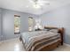Bedroom with a ceiling fan, two windows, and tile flooring at 18302 Burkholder Cir, Port Charlotte, FL 33948