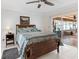 The spacious main bedroom has sliding glass door access to the screened lanai and a ceiling fan at 18302 Burkholder Cir, Port Charlotte, FL 33948