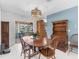 The dining room offers a rustic wood table set with backyard patio access and vintage hutch at 18302 Burkholder Cir, Port Charlotte, FL 33948